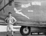Flyer standing with B-24/F-7 "Nosie Rosie." 24th Combat Mapping Squadron, 8th Photo Reconnaissance Group, 10th Air Force