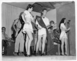 Variety skit at a USO show in Gushkara, India, during WWII.  The boxes in front of the band players are labeled 748th ROB (748th Railway Operating Battalion).