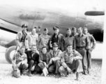 Alice Chong on the Kunming air strip posing before a C-54 with some of her 14th U.S.A.A.F buddies in 1944. Note the blood chit prominently-displayed inside the flying jacket of the Colonel Pilot at center rear. Captain Addison Bailey (in dark shirt) to Alice’s immediate right-all others unidentified.