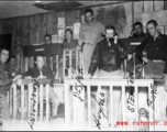 Scene of the workings of the Fighter Control Squadron, 51st Fighter Group, 14th Air Force, as the team works to plot and intercept Japanese planes. Left to right: Lt. Raymond E. Wilson, Capt. Spencer Lansdown, Capt. Dale D. Desper, Col. Louis R. Hughes, Jr., Capt. Thomas E. Stenton, "Buttons" the puppy, and Capt. Glade C. Burton.