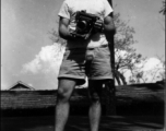 Richard C. Barnhard poses with camera in hand.  Photos taken by Robert F. Riese in or around Liuzhou city, Guangxi province, China, in 1945.