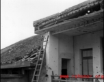 Bomb damage to a building at an American base in China during WWII.