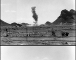 A P-40 fighter burns in the distance, October 9, 1944.  This is in Guangxi province, either Guilin or Liuzhou.