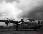 A B-24 in the CBI, with heavy storm clouds overhead.