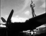 An American standing on a wing of a B-24 in the CBI.