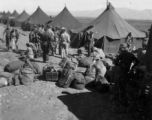 GI bags piled for another move at a housing area at an American base in the CBI.