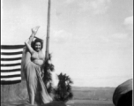 During a USO show at an American airbase Betty Yeaton performs for the service men. October 1944.