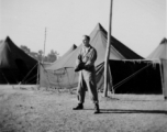 GI with mitt playing baseball at a tent city in Kunming, China, during WWII.