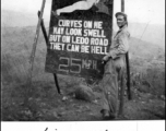 Eye-catching sign along the Ledo Road encouraging GI drivers to slow and take care on their way to China, during WWII.   Photo from Frank Wright, 885th Ord H.A.M. Co.