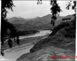 A river valley in SW China, either Yunnan or Sichuan, during WWII, with a pedestrian rope bridge across the river.  Photo from Dorothy Yuen Leuba.