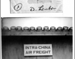 Sgt. Lewis, 12th Air Service Group, standing at a door labeled "Intra-China Air Freight" at Peishiyi, 1945.   Photo from Dorothy Yuen Leuba.