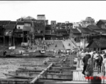 Looking toward the other side of Liuzhou on the boat bridge. Johnnie Burns is a couple of boats ahead, looking back. The barge is off to the left where the kids are swimming.  From the collection of Frank Bates.