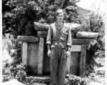 GI Poses with Chinese grave marker in Yunnan, China, during WWII.