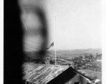 An American flag at half-mast in the barracks area at an American base in Yunnan, China, during WWII.