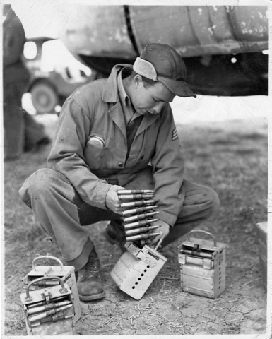 Staff Sergeant Richard D. Arbogast loading .50 cal bullets