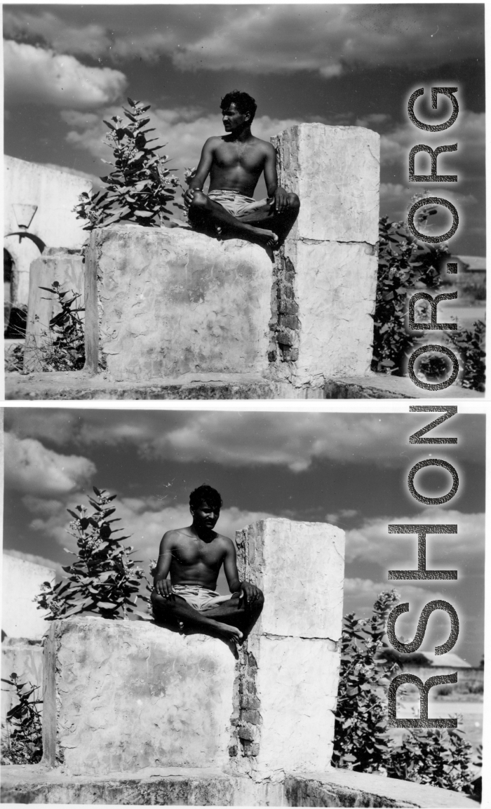 Man sits cross-legged on stone.  Scenes in India witnessed by American GIs during WWII. For many Americans of that era, with their limited experience traveling, the everyday sights and sounds overseas were new, intriguing, and photo worthy.