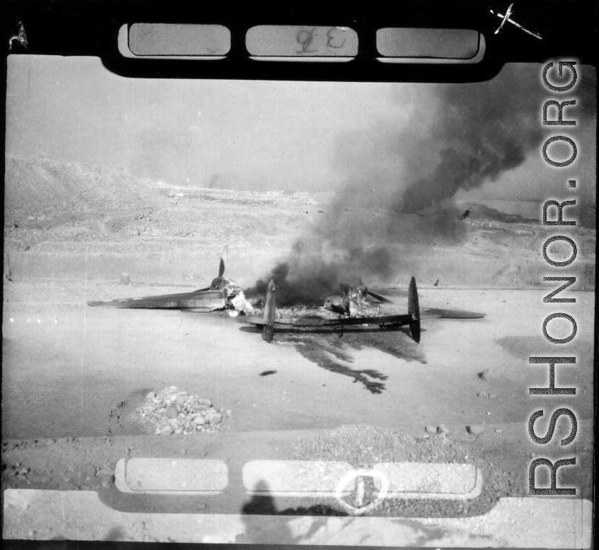 A P-38 fighter destroyed on the ground by a bombing.