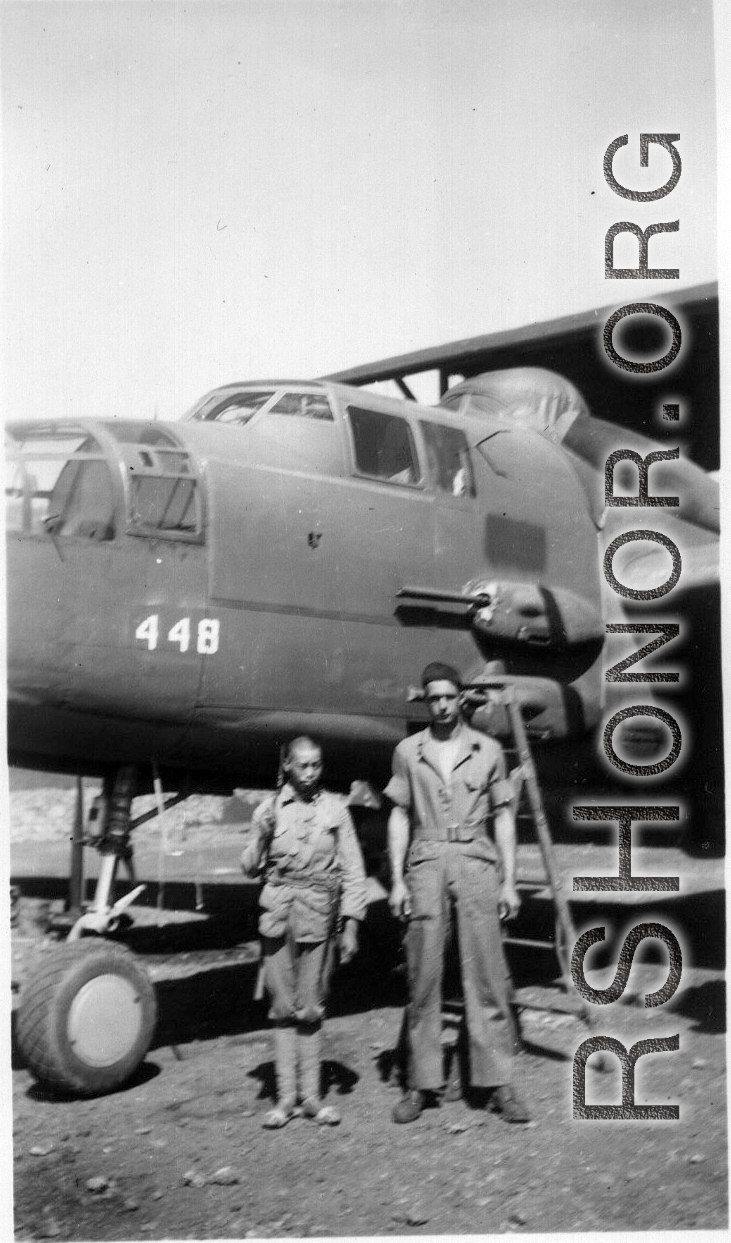 Chinese soldier and American engineer stand before the new 25, #448, Yangkai, May 1944.  Unknown, Frank Bates.