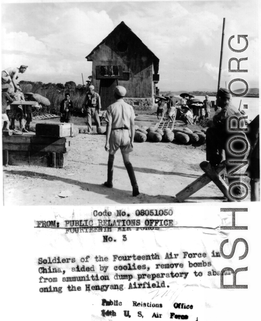 Soldiers of the 14th Air Force, aided by Chinese soldiers and workers, remove bombs from the ammunition dump preparatory to abandoning the Hengyang Airfield.