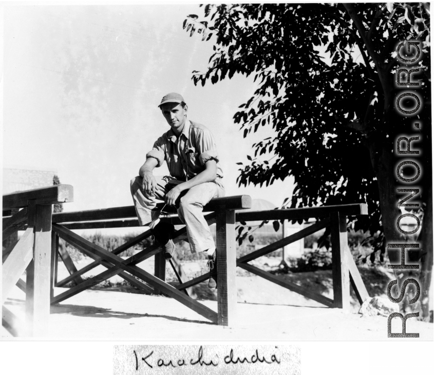 GI enjoying a moment sitting on a rail in Karachi, India, on the way back to the US after the war.