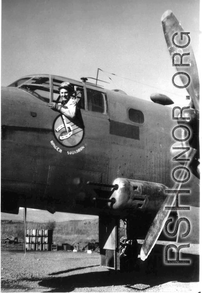 First Lt. Richard P. Kendall, pilot, leans out window of a 491st Bomb Squadron's B-25D aircraft in a revetment at Yang Chiseh Airfield, Yangkai, Yunnan Province, China. This plane has been modified with the twin .50 caliber machine gun side packs on lower fuselage side. Another would be on the opposite, starboard, side of the plane.