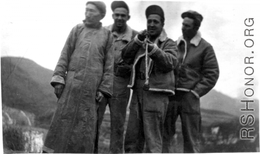 GIs pose with Chinese man and try out his long pipe. During WWII.