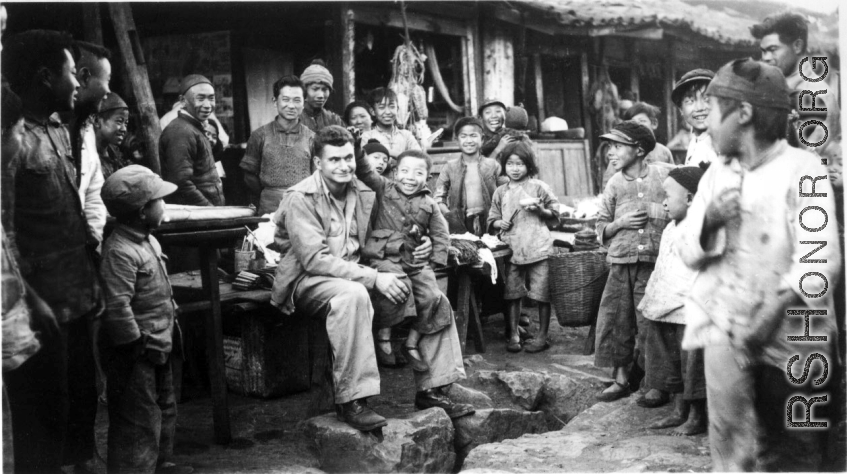 At the hardware stand, GI Fred Nash, with appreciative local people. Yangkai Village, Spring 1945.