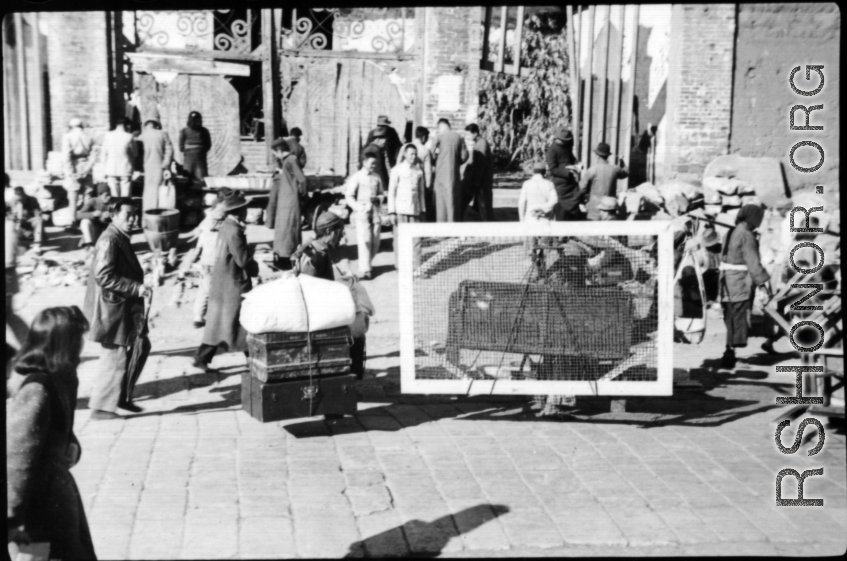 People transporting possessions in Guilin during WWII, possibly in preparation to fleeing in the face of the Japanese Ichigo campaign.