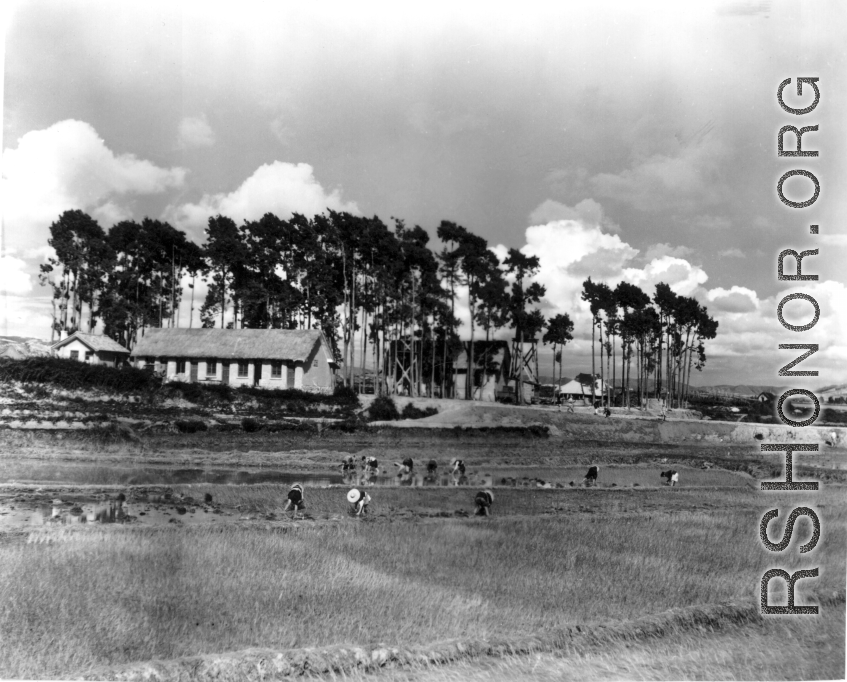 Chinese farmers work in fields outside an American air base in SW China during WWII.