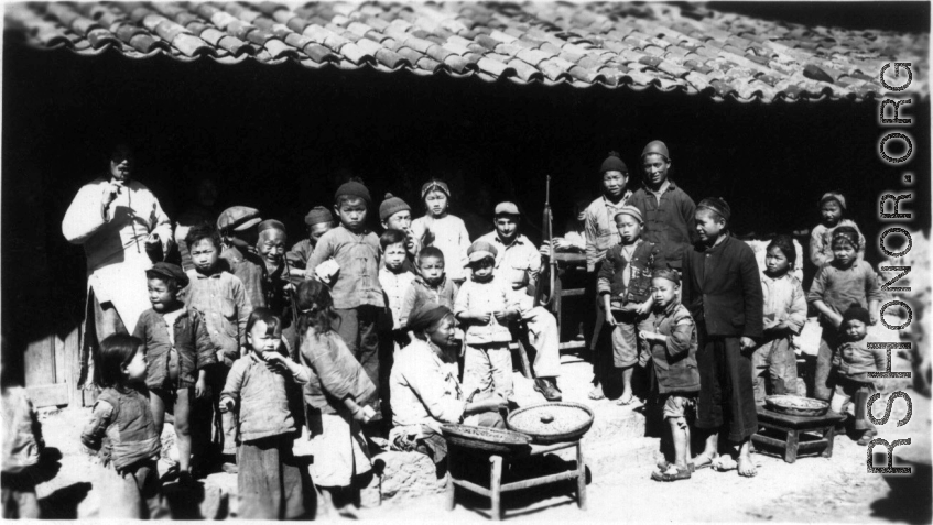 Restaurant 10 miles east of Yangkai, Spring 1945.  Clayton E. "Fred" Nash, holding carbine, does not quite blend in.