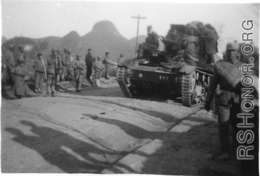 Marching Nationalist troops and an Nationalist tank Chinese armored tank (possibly a soviet T-26b) on the road in southern China. During WWII.