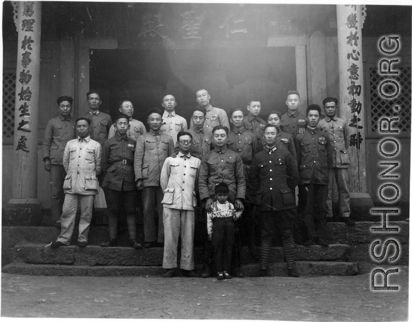 A group of local soldiers--likely a local militia or local KMT-affiliated warlord soldiers--in Yunnan, China, during WWII. They are standing before a temple.