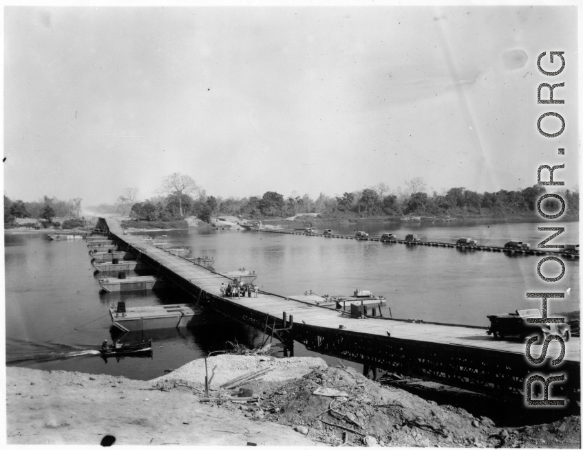 797th Engineer Forestry Company in Burma: Enormous floating bridge over a river on the Burma Road.  During WWII.