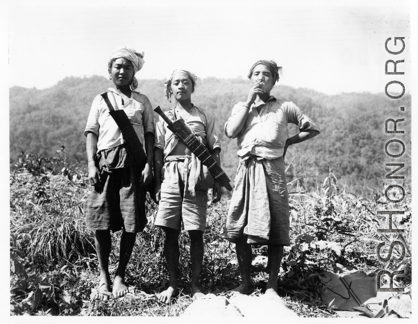 Local people in Burma near the 797th Engineer Forestry Company--three Kachin men with large knives.  During WWII.