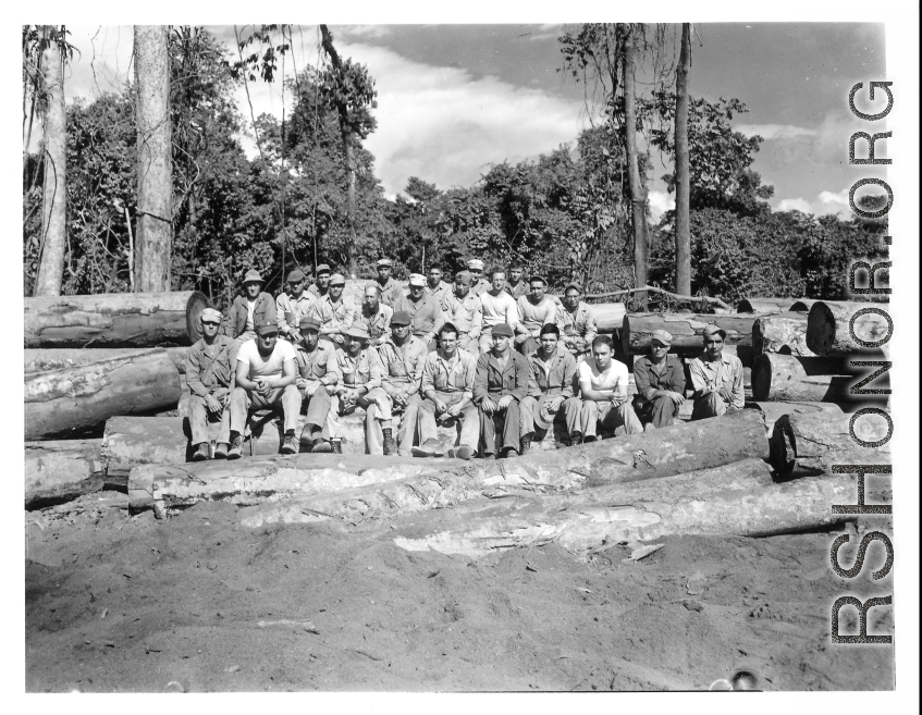 Engineers of the 797th Engineer Forestry Company pose on logs in Burma.  During WWII.