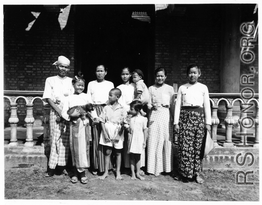 Local people in Burma near the 797th Engineer Forestry Company--Man, women, and children, and a happy puppy.  During WWII.