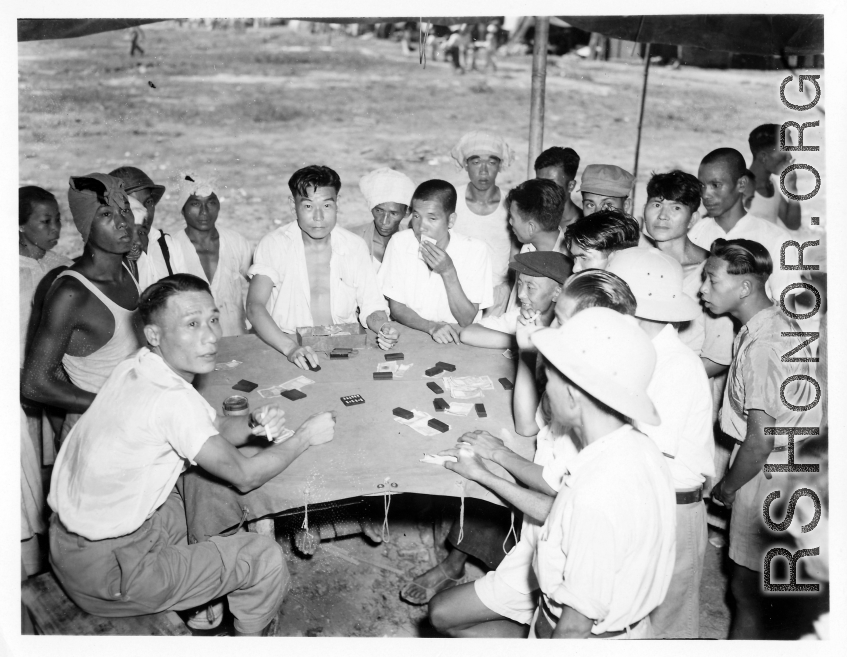 Men gambling at an activity in Burma.  In Burma near the 797th Engineer Forestry Company.  During WWII.