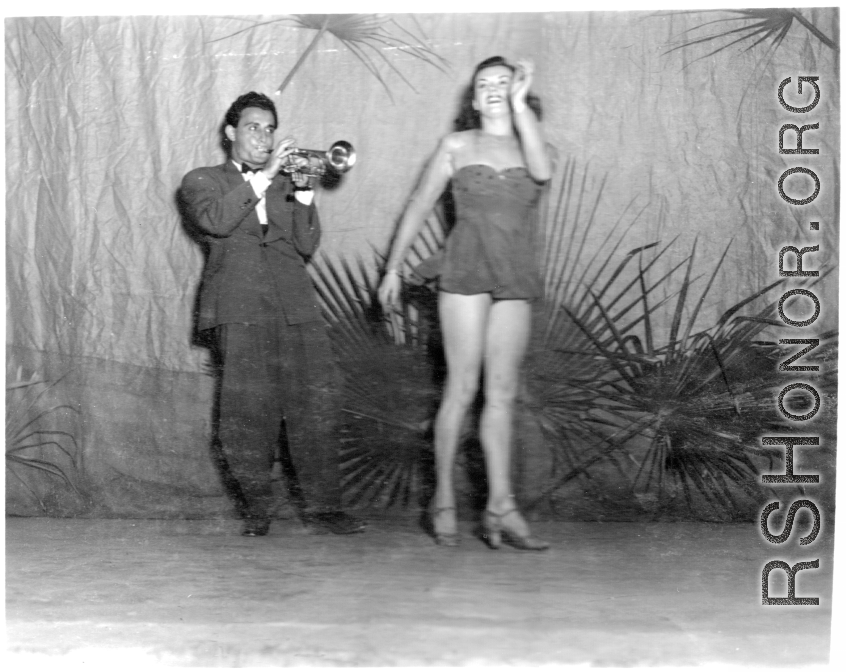 Dancing at a USO show in Gushkara, India, during WWII.  The boxes in front of the band players are labeled 748th ROB (748th Railway Operating Battalion).