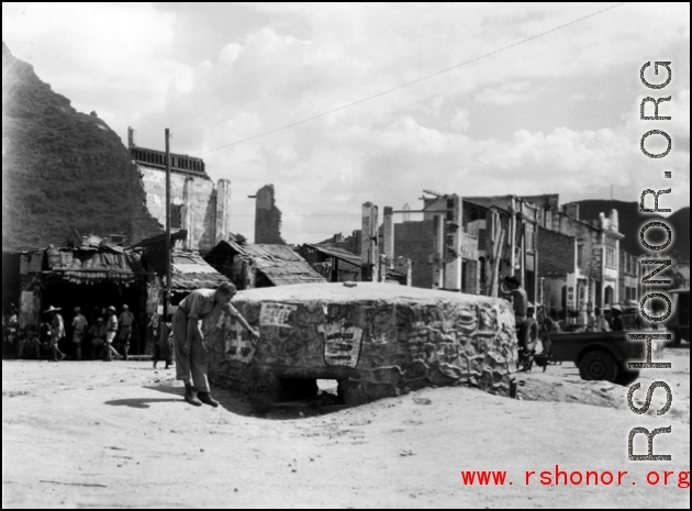 A GI inspects a bunker near Liuzhou in WWII, in 1945.