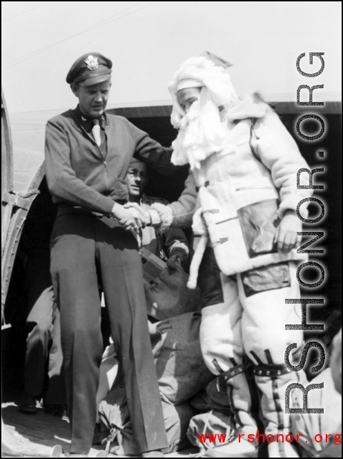 Santa Claus, in full costume, makes an air transport arrival in the CBI during WWII.
