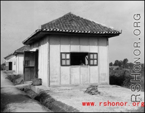 Several small buildings on a base in China during WWII.