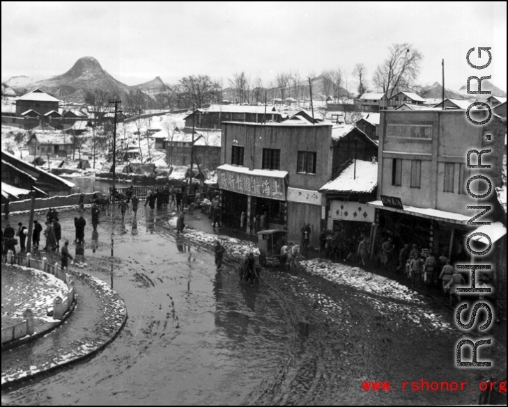 Street scene on a snowy day in China during WWII, probably in Guangxi province.  From the collection of Hal Geer.