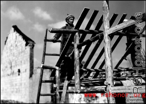 Man building roof of house in SW China during WWII.
