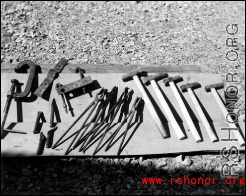 Tools laid out, possibly for sale.  In Guangxi, probably Guilin.  From the collection of Hal Geer.