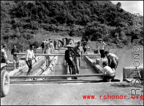 Getting a few last vehicles across a bridge at Liuzhou before the Japanese advance in the fall of 1944. The bridge decking planks have been removed, but there are enough free planks that by moving a few planks, then moving forward a bit on those planks, then moving a few more planks, the jeep can creep across.