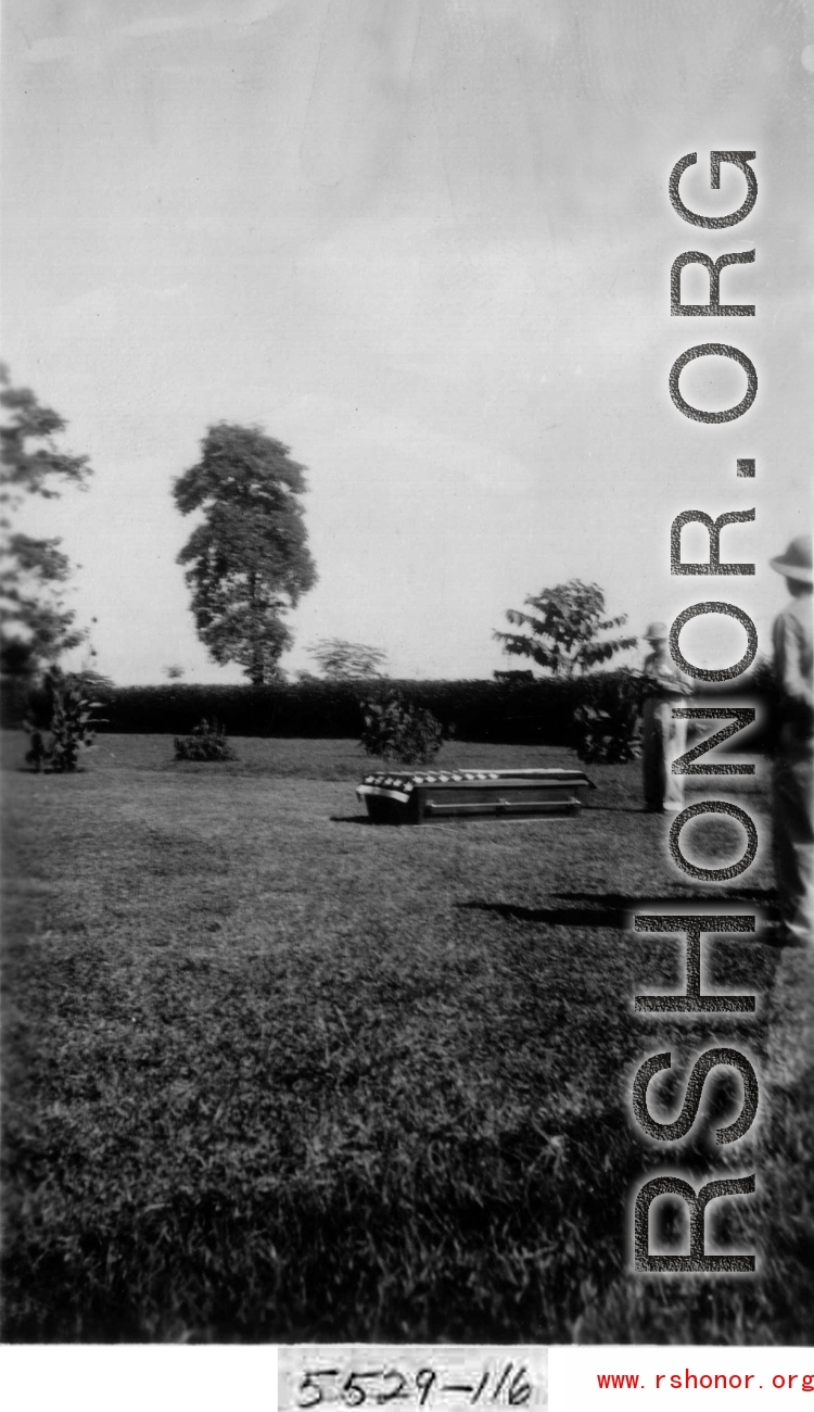 5529-116 A funeral in the CBI. Someone reads over a coffin with an American flag draped over its top, resting on a lawn somewhere in the CBI.