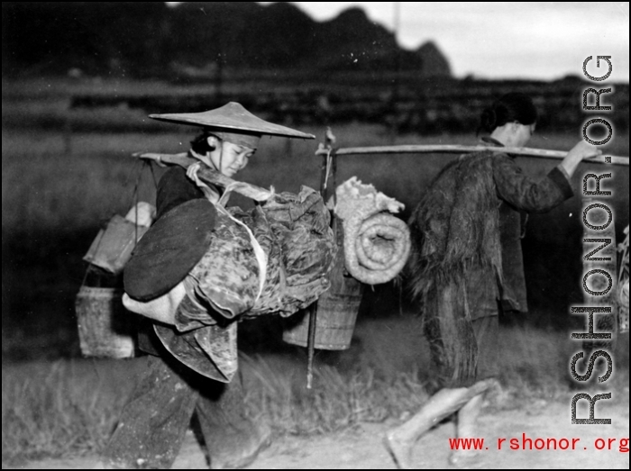 Refugees carry possession while fleeing around either Liuzhou or Guilin during the evacuation before the Japanese Ichigo advance in 1944, in Guangxi province.