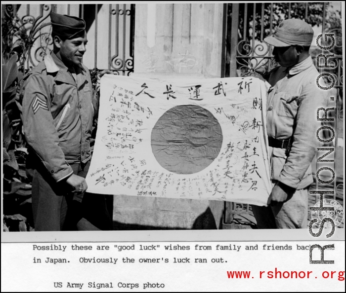 An American and a Chinese soldier show a  captured Japanese Good-Luck Flag  (寄せ書き日の丸) collected on the battleground in the CBI during WWII.  US Army Signal Corps Photo.
