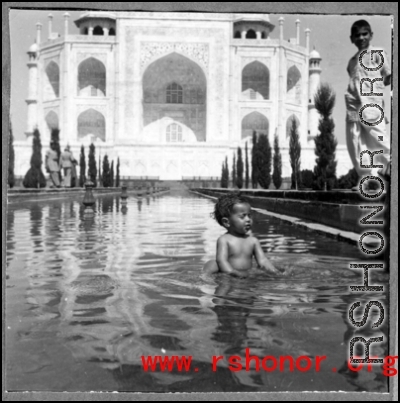 A kid playing in reflecting pool at Taj Mahal during WWII.