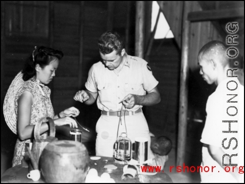 Americans and Chinese work together to provide medical treatment during WWII in China.  Note the sick Chinese man on the floor.